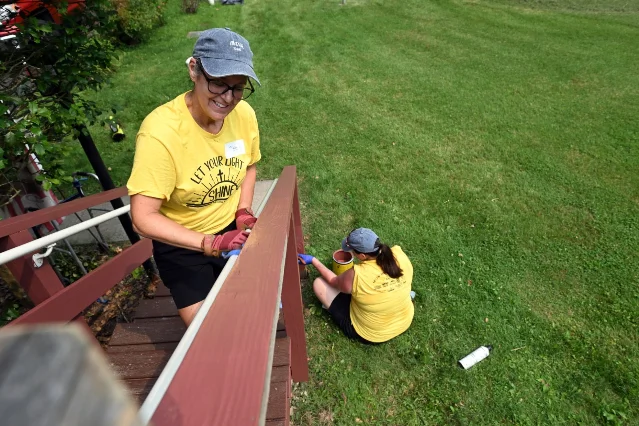 Volunteers work on a deck.