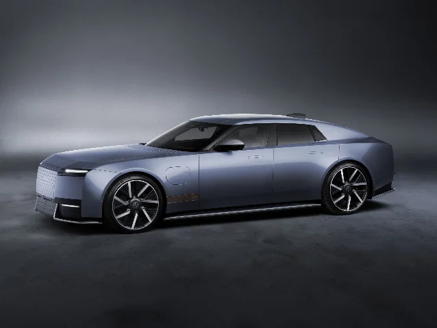 A pale blue 2028 Jaguar Type 01 sedan photographed three-quarter front in a studio
