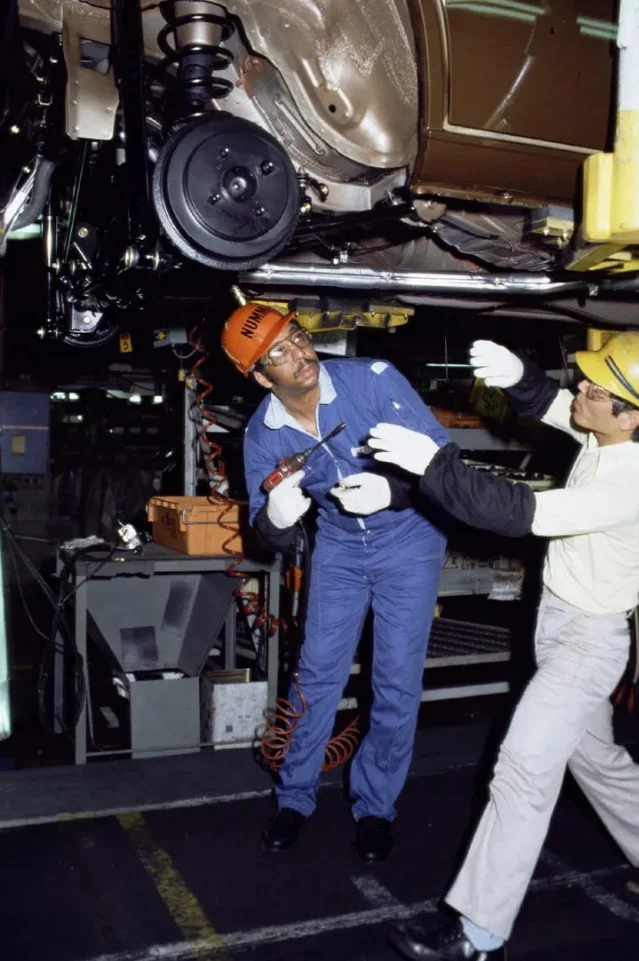 A NUMMI trainee receiving practical training from peers at Toyota's Takaoka plant