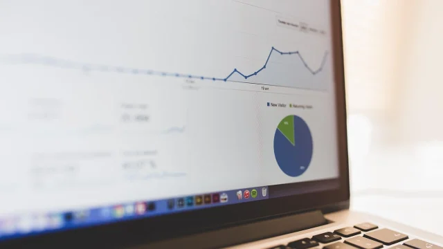 Business data presentation charts on laptop screen showing performance metrics