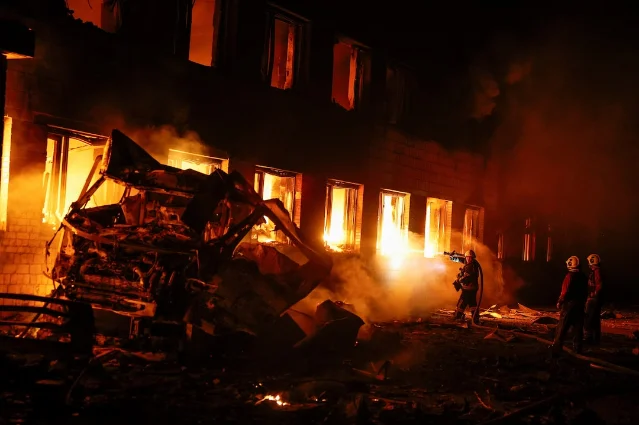 Firefighters work after a Russian missile strike in Kyiv