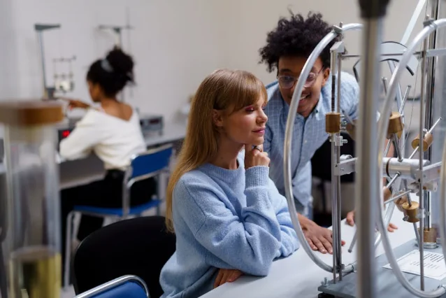 Diverse group of graduate students collaborating in a research lab environment