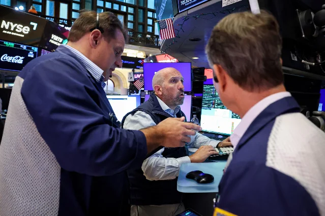 Traders work on a stock-exchange floor