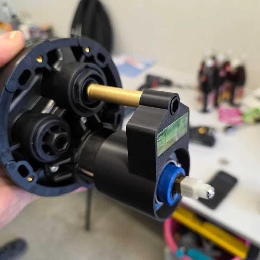 Printed Grohe valve-leveling adapter holding a small bubble level against a valve assembly
