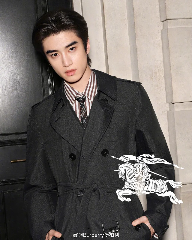 张康乐身着 Burberry 深灰色格纹风衣出席品牌活动,画面右下角有 Burberry 马术骑士标