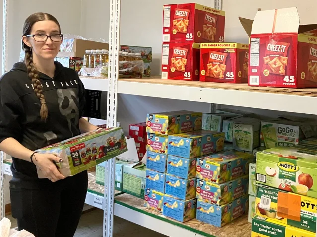Rachel Caprio organizes a new shipment for the Backpack Program.