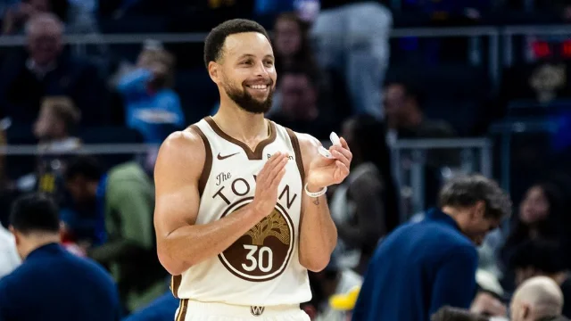 Stephen Curry, a Golden State Warriors guard, claps during a game.