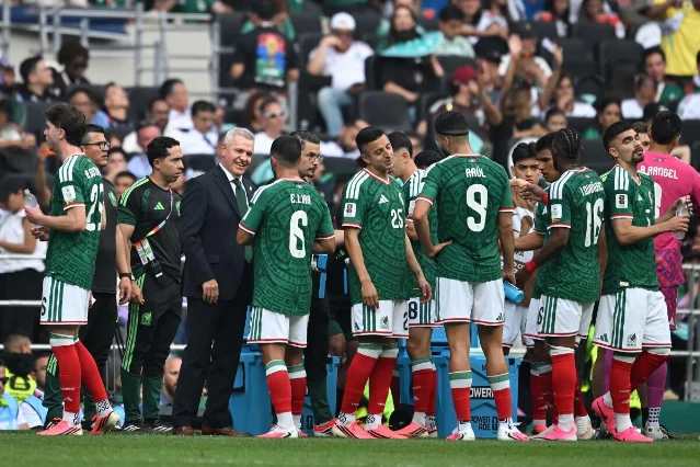Mexico coach Javier Aguirre talks with players during a World Cup hydration break