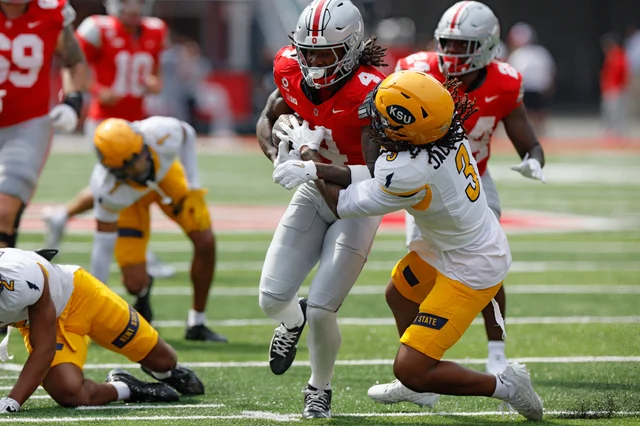 Ohio State receiver Jeremiah Smith is dragged down by a Kent State defender
