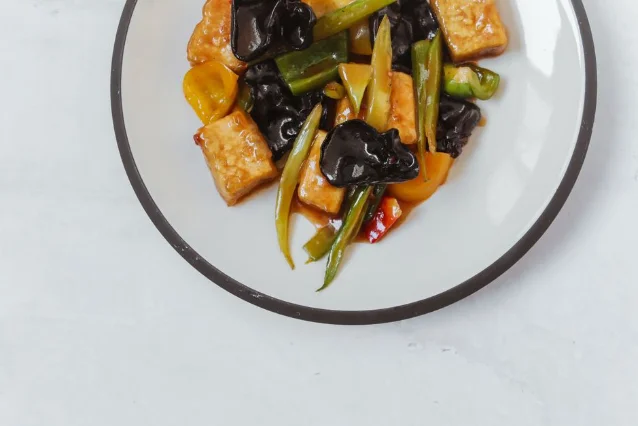Colorful tofu stir-fry with vegetables on a ceramic plate
