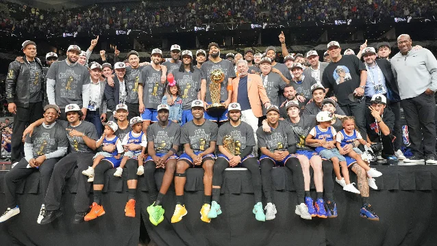 The 2026 NBA champion New York Knicks pose with the Larry O'Brien Trophy