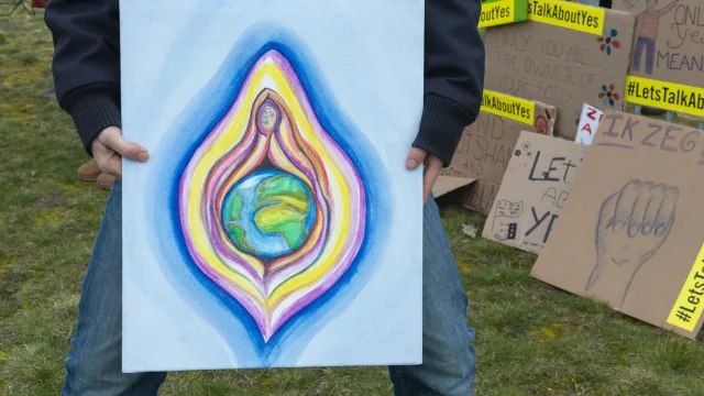 Protesters holding signs during a campaign for the Dutch word vulvalippen