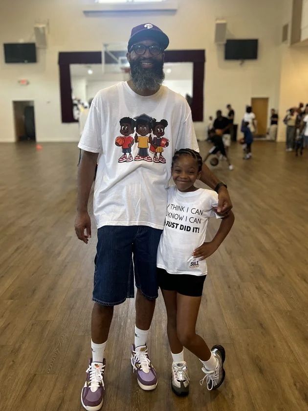 Darryl Glover stands with his daughter at the Sole Scholars event.
