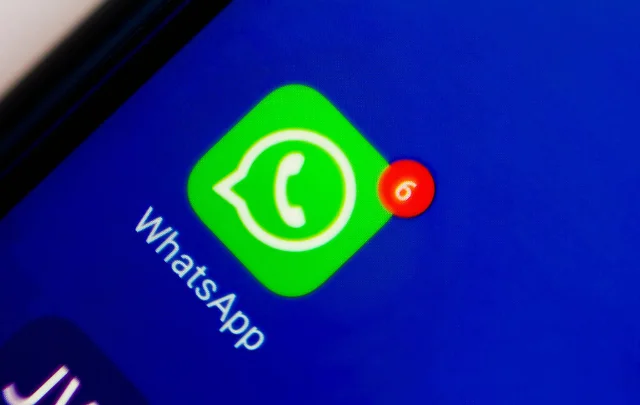 WhatsApp app logo on a smartphone screen, central to the Texas encryption dispute