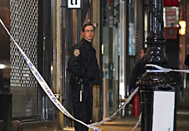 NYPD 制服警员在拉了警戒线的犯罪现场值守