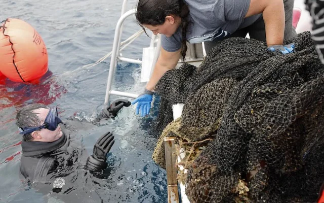 A diver works beside a tangled net on the boat after the Catalina recovery.