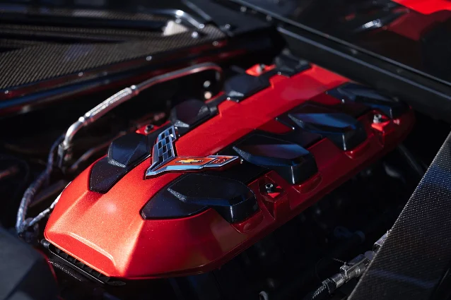 A red Chevrolet Corvette engine cover carrying the Corvette crossed-flags badge