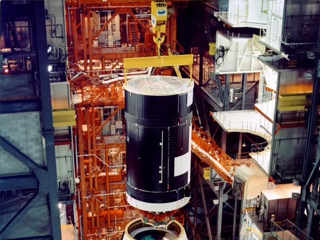 The Skylab workshop being lowered onto a Saturn V stage inside the assembly building