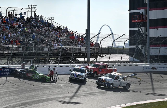 Zane Smith's car being towed from the track after a brake rotor failure