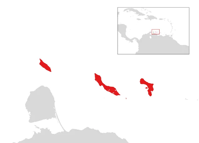 A plain map showing three red island shapes off a grey coastline, with a small inset map of the Caribbean