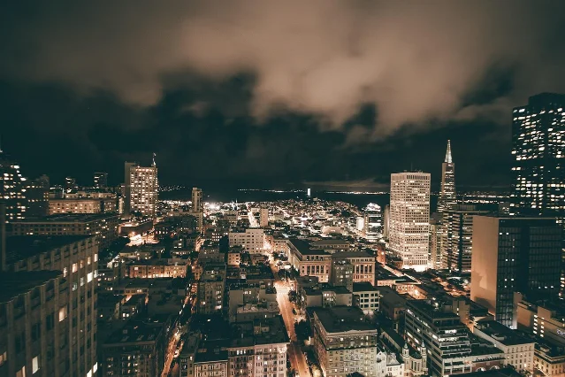 SF Bay Area skyline at dusk with downtown skyscrapers and city lights
