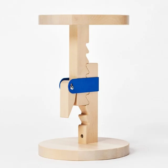 IKEA PS 2026 birch stool on white background — natural birch body with bright blue ratchet lever at middle