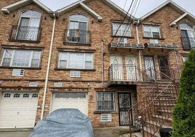 Exterior of 2809 Ely Avenue Unit 3 condominium building, Bronx, NY — active Auction.com REO with estimated market value