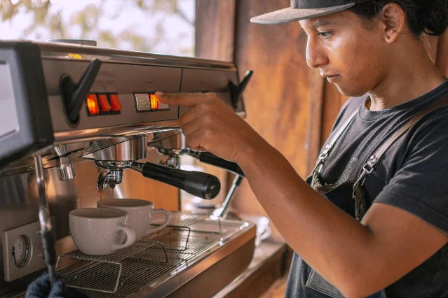 Barista operating a coffee machine