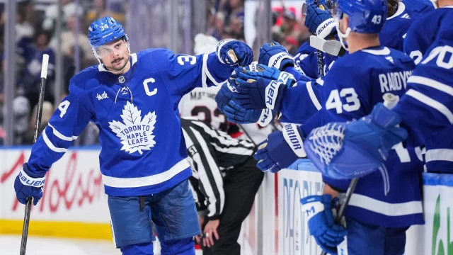 Toronto Maple Leafs players celebrating on the bench