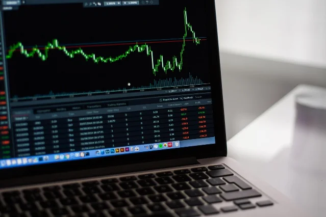 Stock market trading data on a MacBook screen
