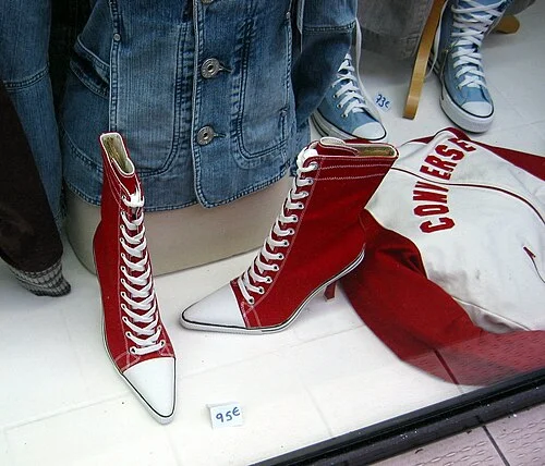 Converse Chuck Taylor shoes on a Paris street, a long-running emblem of the brand's crossover from sport to daily life