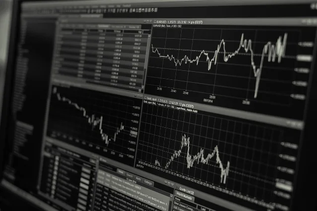 Stock trading monitors showing financial market data