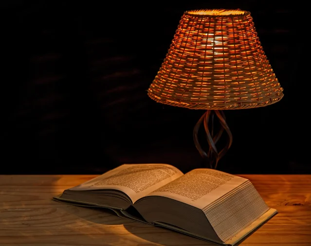 Bedside lamp and open book — low-light reading is an effective pre-sleep wind-down