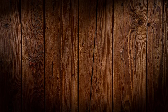 Close-up of wood grain running the length of dark wooden boards