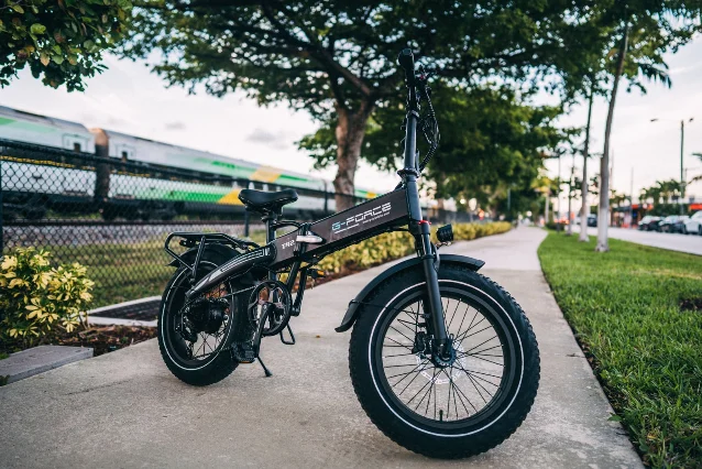 Compact folding-style eBike parked on a sidewalk