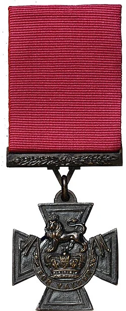 The Victoria Cross: a crimson ribbon above a bronze cross