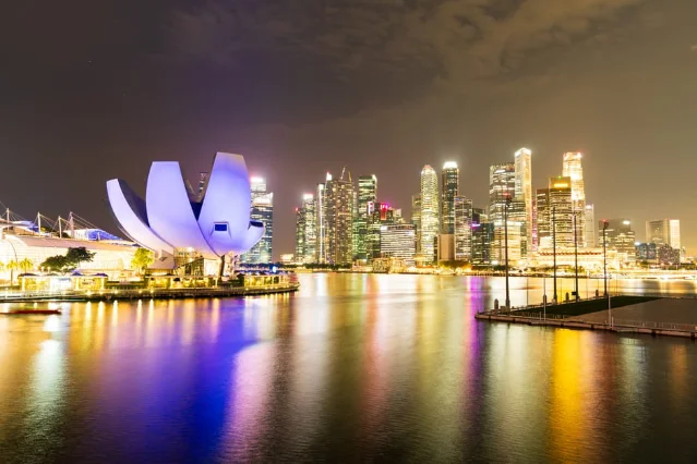Singapore's illuminated skyline at night, venue for Shangri-La Dialogue 2026
