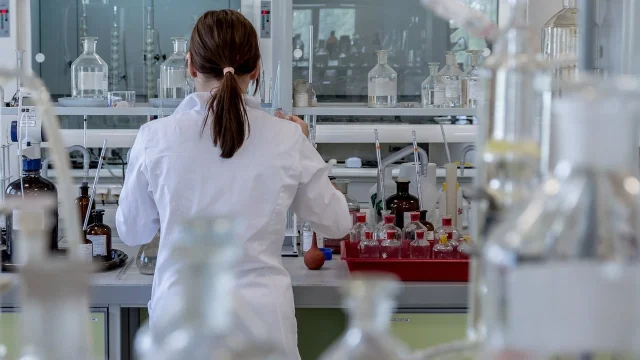 Blue-lit laboratory — test tubes and analysis equipment used in pharmaceutical research