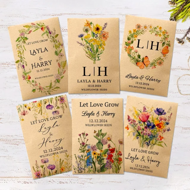 Six kraft paper wildflower seed packets with 'Let Love Grow' text and personalized couple names on white distressed wood