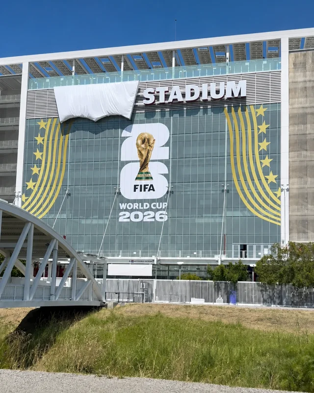 Levi's Stadium facade with the logo wrapped per FIFA branding rules — the distinctive batwing silhouette remains fully recognisable