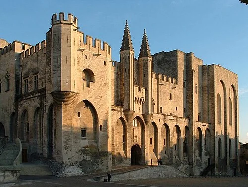 The stone facade of the Palais des Papes in Avignon