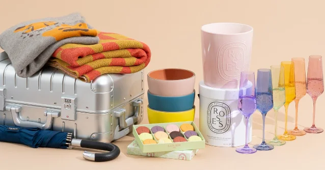 An assortment of luxurious gifts including jewelry, a roasting pan, and a throw blanket