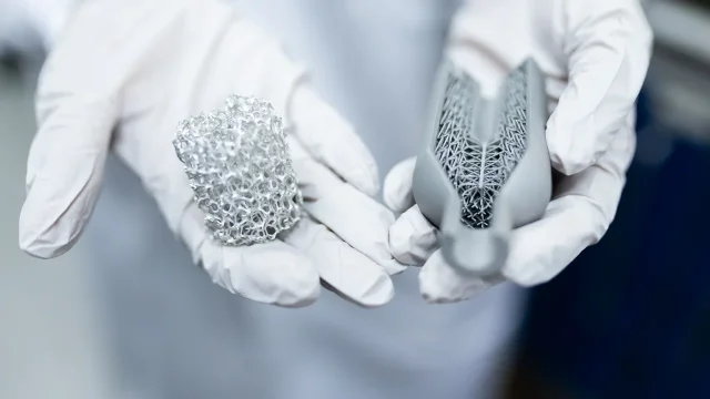 Engineer holding 3D printed metal structures