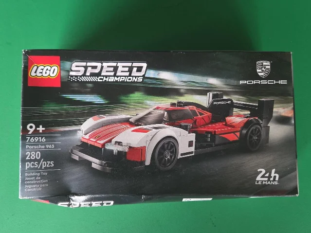 Factory-sealed LEGO Speed Champions 76916 Porsche 963 box showing shelf wear along the lower edge