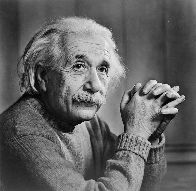 Einstein's iconic black-and-white portrait, photographed by Yousuf Karsh — Einstein's gaze directed away from the camera, expression deeply thoughtful