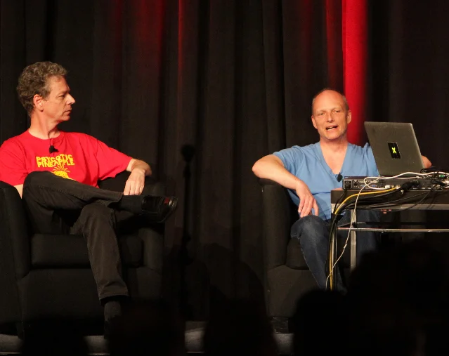 Paul Reiche III and Fred Ford speaking onstage at a game-development event