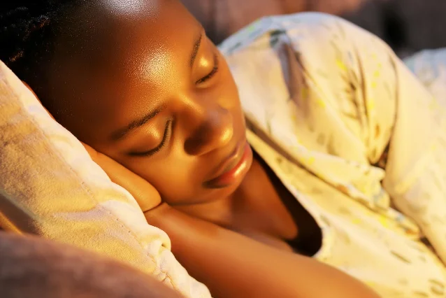 Young woman sleeping peacefully, eyes closed, in soft natural light