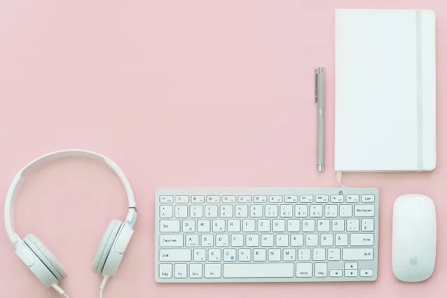 Compact WFH desk setup with laptop, keyboard, and clean workspace