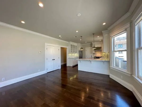 Renovated open living area with hardwood floors and center-island kitchen at 1245 Washington St, Nob Hill