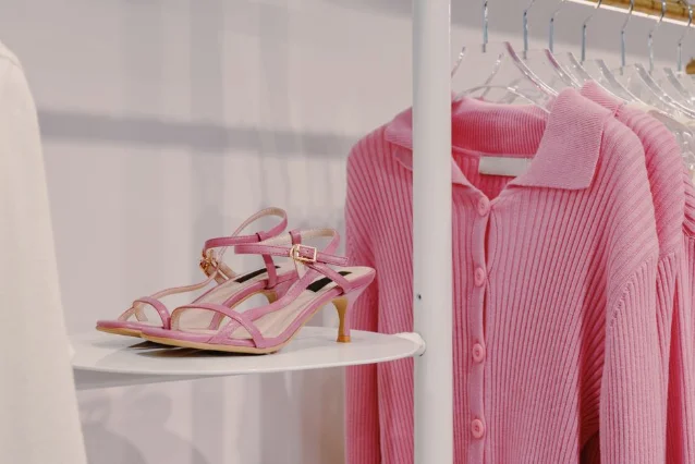 Sandals and knitwear displayed on a boutique shelf